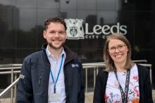 Jak Lomas and Hannah Wood are civil engineers and are pictured in front of the logo for Leeds City Council