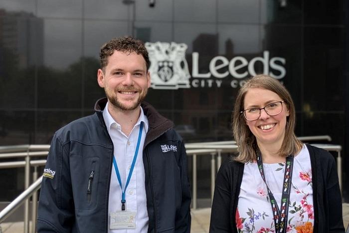 Jak Lomas and Hannah Wood are civil engineers and are pictured in front of the logo for Leeds City Council